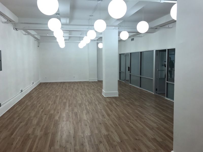 Plug and play commercial loft space at 115 W 30th Street, with large bullpen and glass offices.
