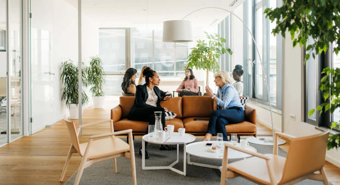 Businesswomen Relaxing in Stylish NYC Office Space.