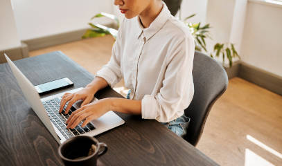 Businesswoman working at desk in a traditional office setting.