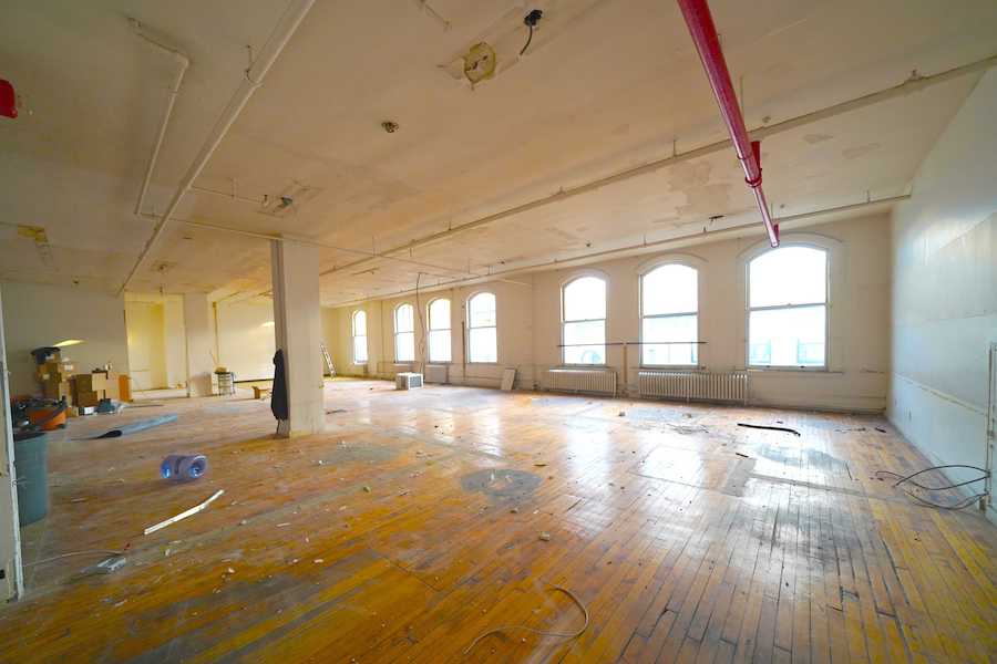 Bright industrial-style Chelsea office space, south-facing windows, hardwood floors.