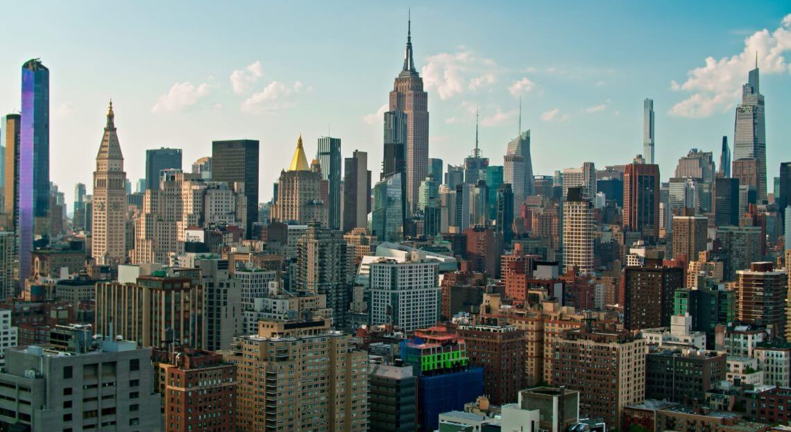 Sunny evening view of Manhattan, highlighting NYC's prime commercial real estate landscape.