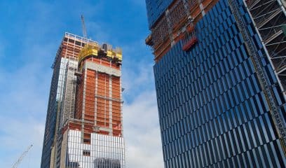 NYC skyscrapers under construction, reflecting dynamic real estate.