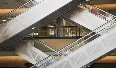 Empty double escalator in an NYC shopping mall, symbolizing the impact of the COVID-19 pandemic.