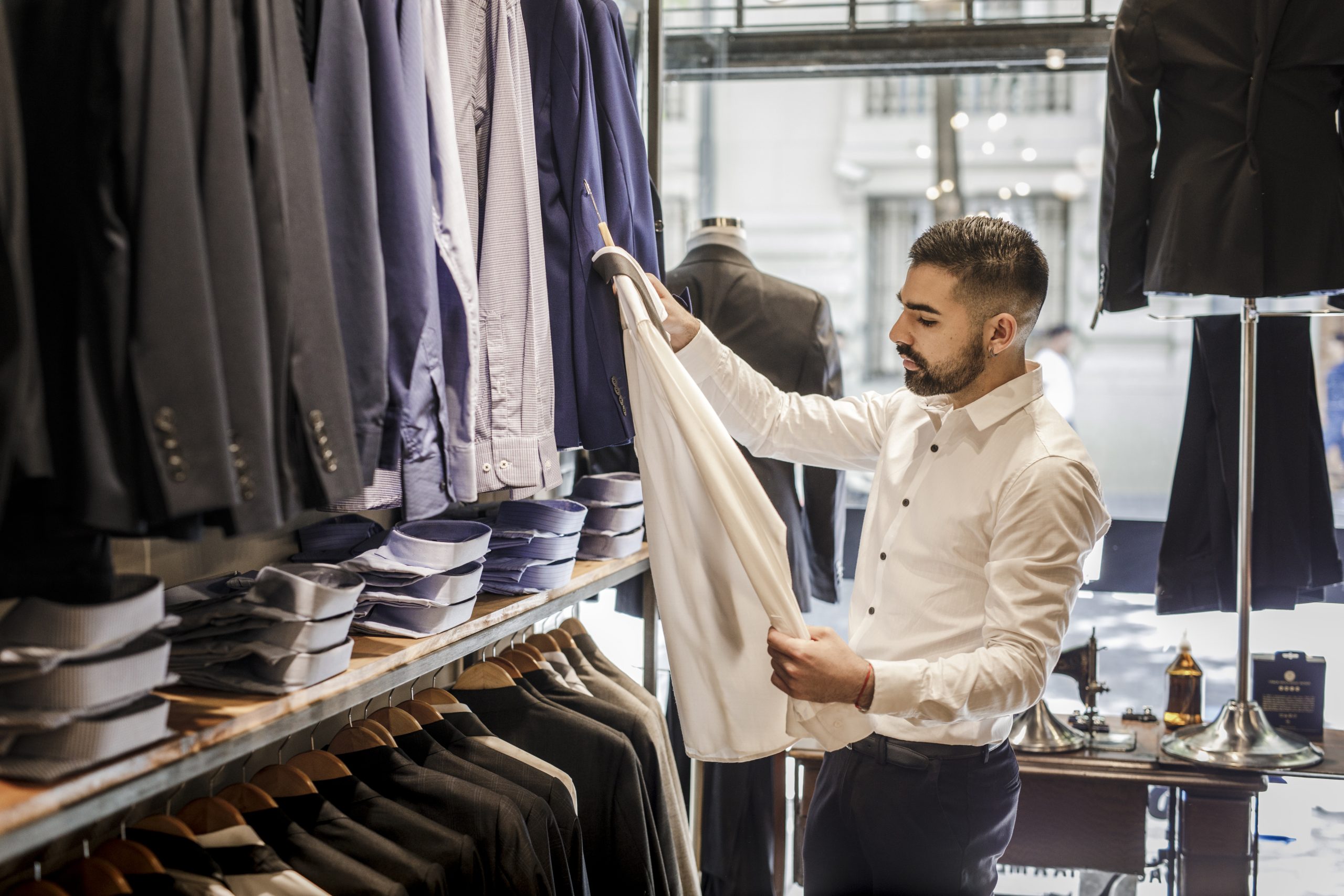 Young businessman browsing shirts in an NYC shop.