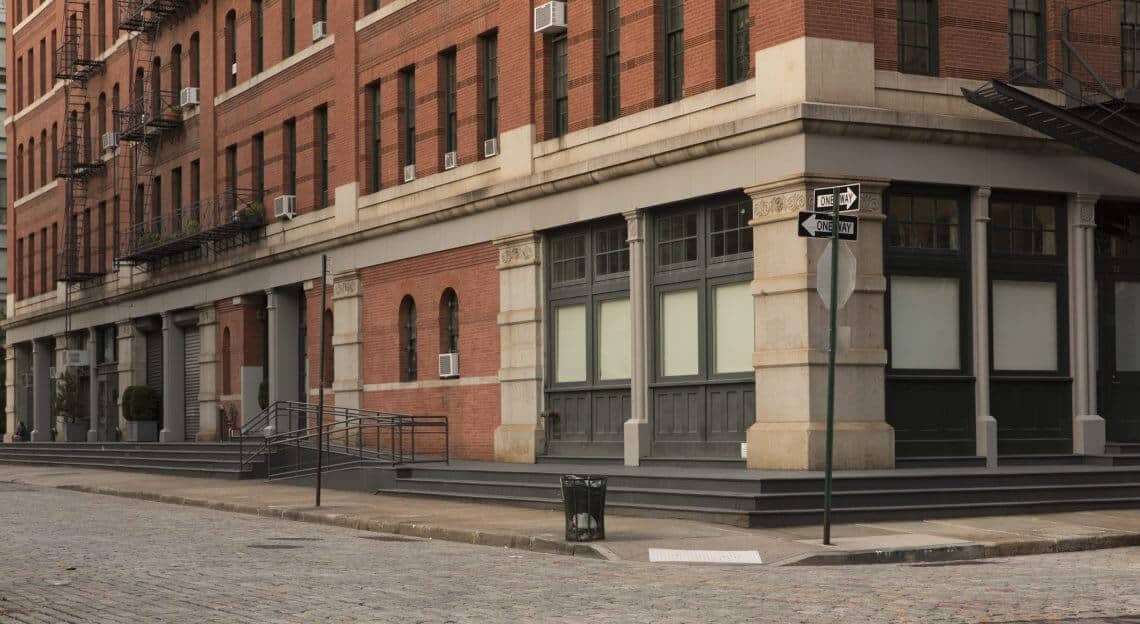 Deserted street during NYC lockdown, echoing the 78% retail sales drop reported in the area.