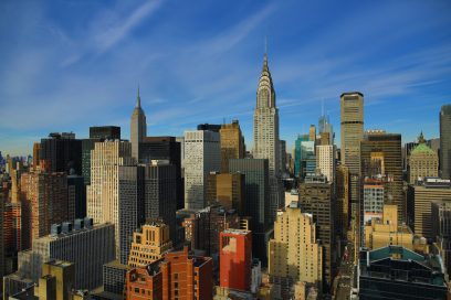 NYC skyline featuring Empire State and Chrysler Buildings, commercial real estate hub.