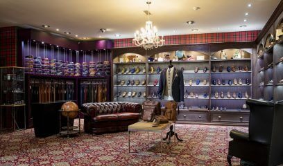 Luxurious interior of a men's clothing shop in NYC, evoking Brooks Brothers' legacy.