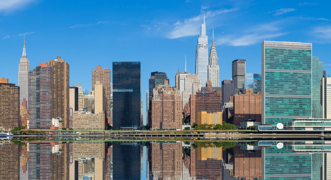 Iconic NYC skyline featuring UN, Chrysler, Empire State, and Manhattan's East Side skyscrapers.