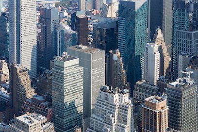 Manhattan's skyline, sunny day, emblematic of high-value commercial real estate.