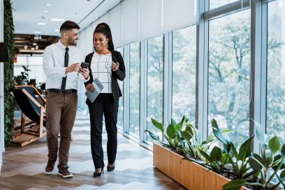 Co-workers in company hallway, reflecting tenant-friendly NYC commercial real estate trends.