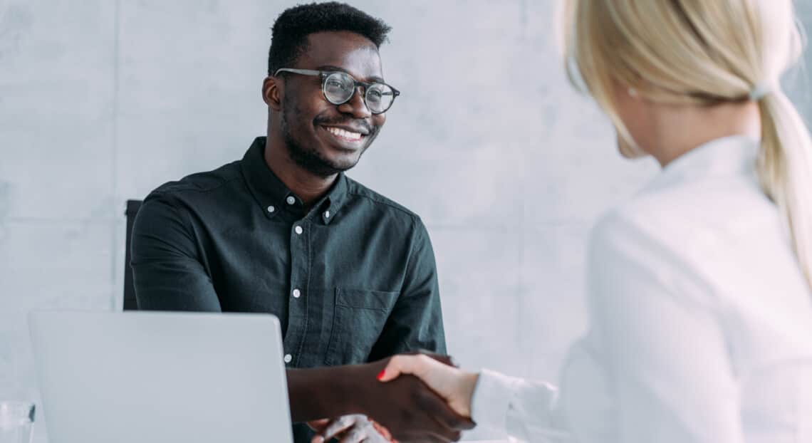 Business people seal the deal with a handshake in NYC office space search.