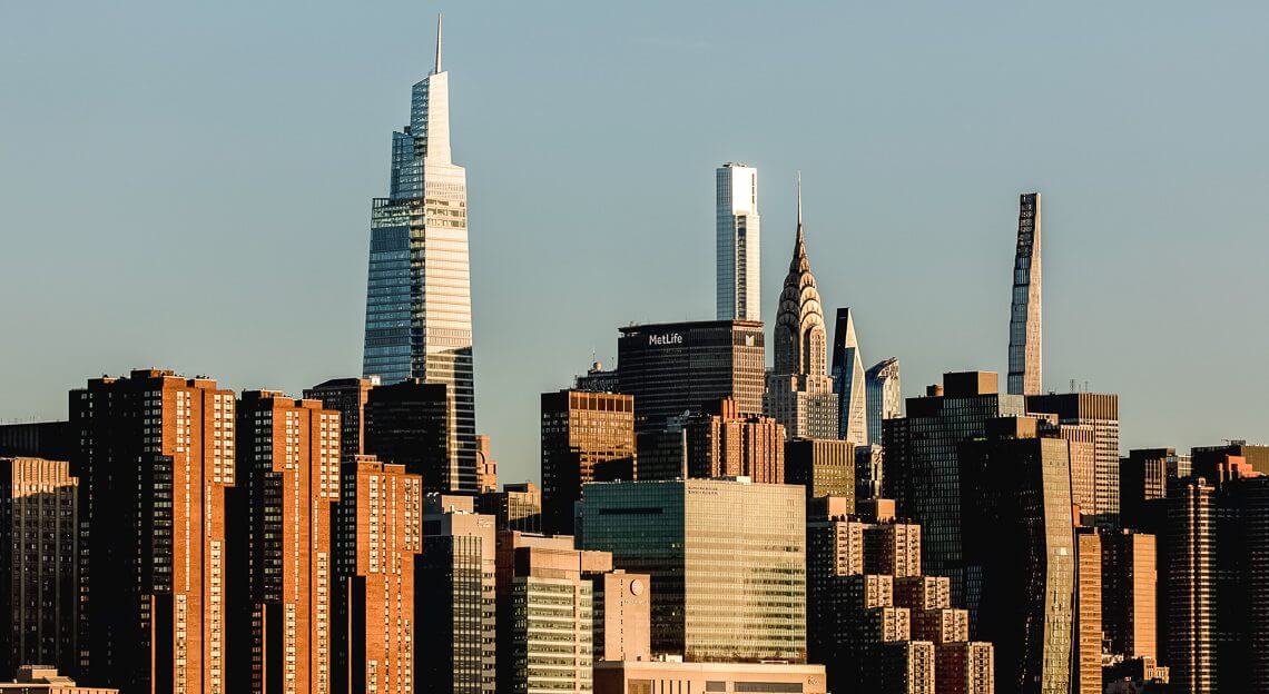 Sunrise over East River, showcasing One Vanderbilt, a landmark in NYC's commercial real estate.