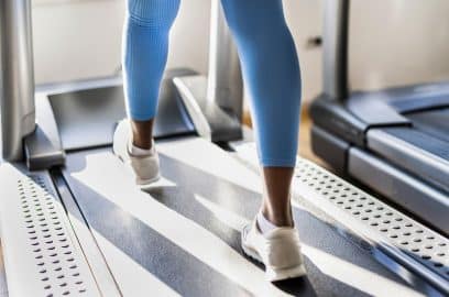 Woman's legs on treadmill, embodying the quest for ideal fitness commercial space in modern NYC.