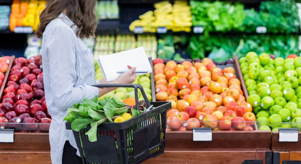 An anonymous woman shops for groceries, reflecting the impact of Amazon Go on NYC retail space.