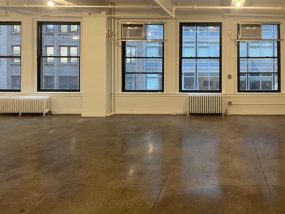 Office loft for lease at 213 West 35th Street: 24/7 attended lobby, close to public transport.