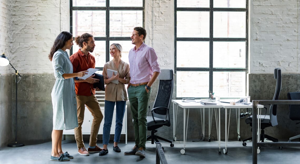 SoHo Office Collaboration: Thriving Design Team in Open Workspace.