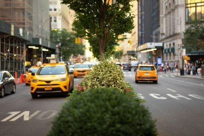 NY's Park Avenue buzzes with taxis, signaling Plaza District's revival.