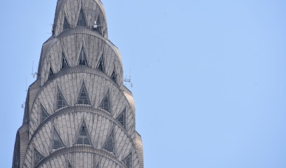 Iconic Chrysler Building pinnacle, symbolizing NYC commercial real estate excellence.