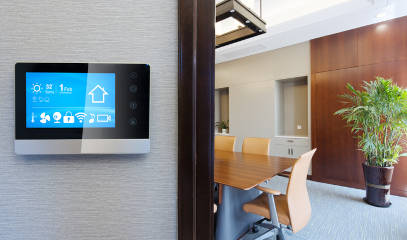 A smart control system with app icons on a digital screen in a modern NYC office