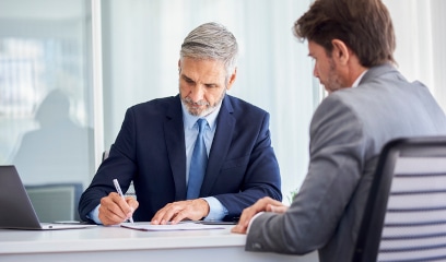 Businessmen signing lease contracts, emphasizing the importance of liability insurance.