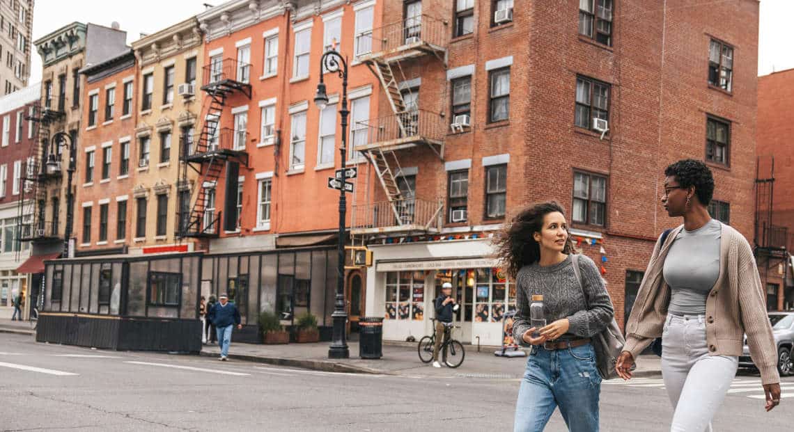 Ethnic Students Walking Past Historic Greenwich Village Stores.