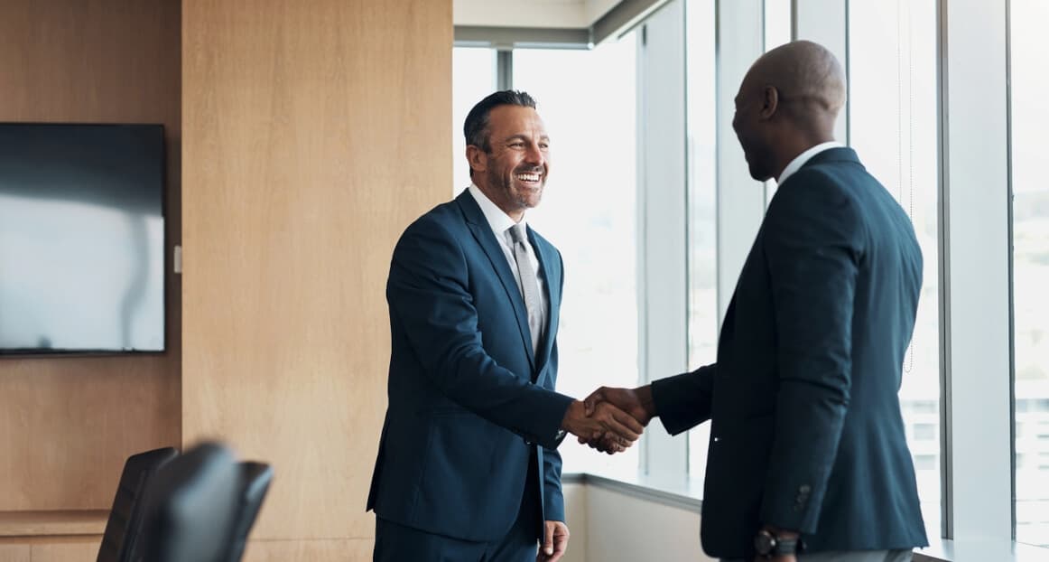 Innovative NYC Commercial Real Estate Broker Assisting Client in Conference Room Meeting.