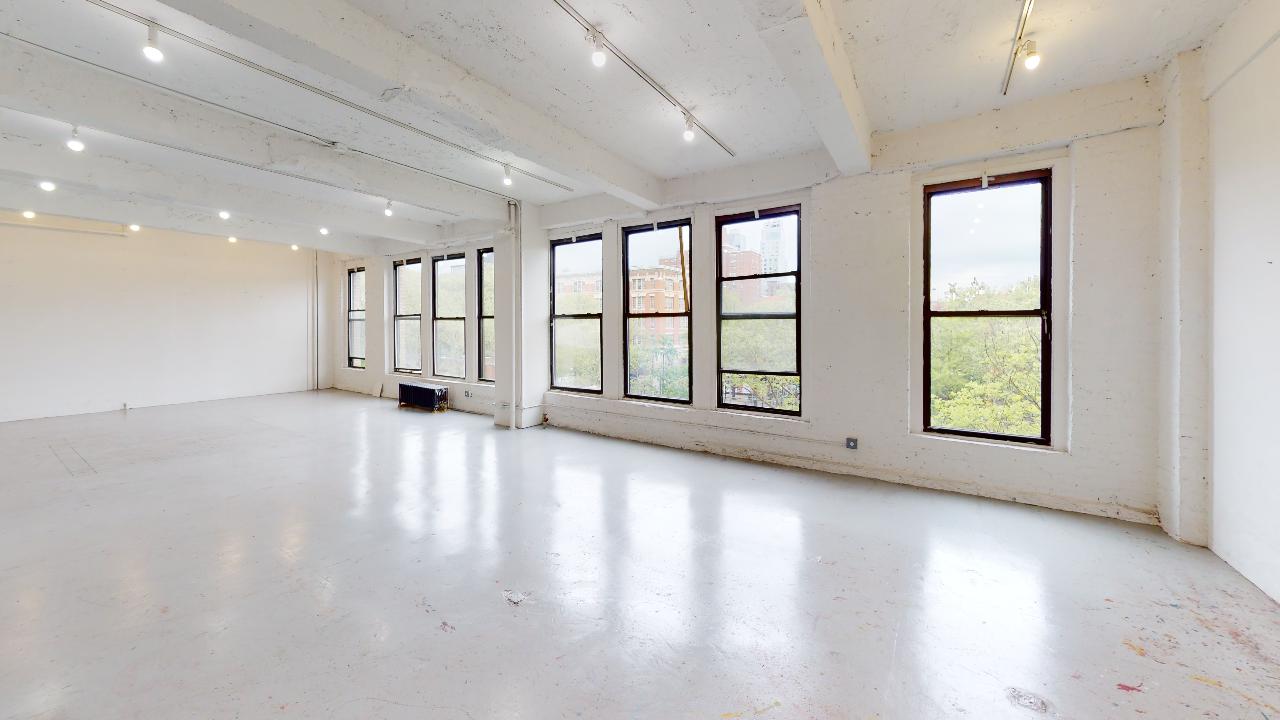 195 Chrystie Loft Suite 400A: Industrial space with large windows, catering to professionals