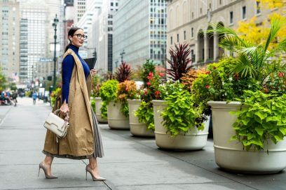 Stylish professional exiting Manhattan building, reflecting NYC's evolving real estate scene.