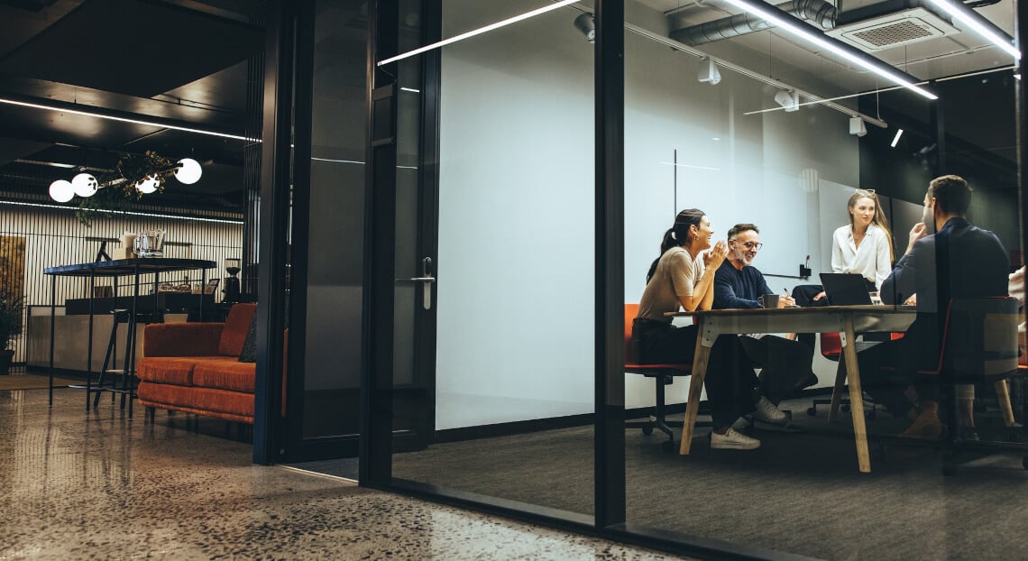 NYC Startup Scene: Colleagues Confer in Glass Boardroom.