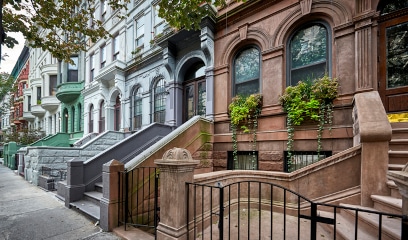 Colorful Bronx brownstones in Mott Haven, showcasing the evolving landscape of NYC real estate.