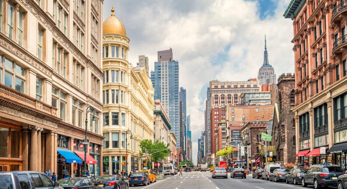 Ornate facades of office buildings on 6th avenue, Chelsea, Manhattan, New York City, USA on a sunny day.