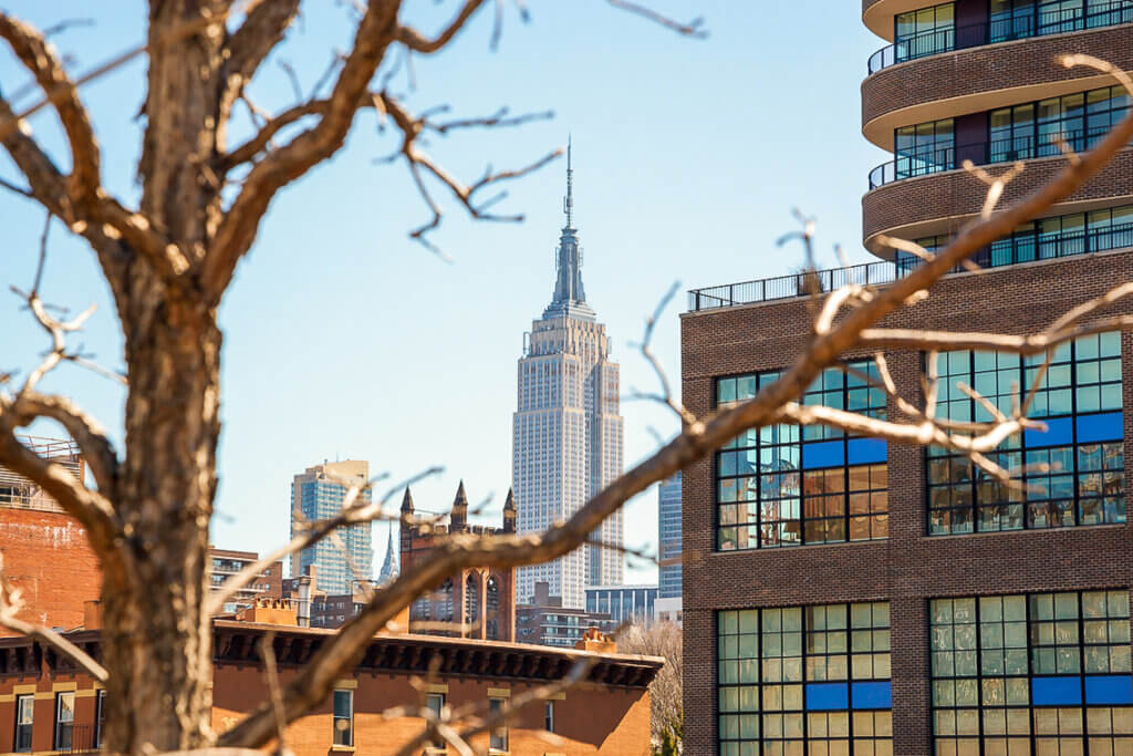 View from NYC's High Line Park in spring with the Empire State Building distant.