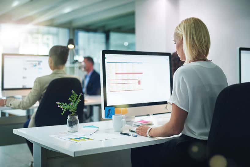 Office workers working on computers at desks in leased office space