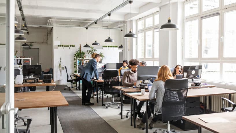 A group of business people working at desks in a modern office space in Manhattan, NYC.