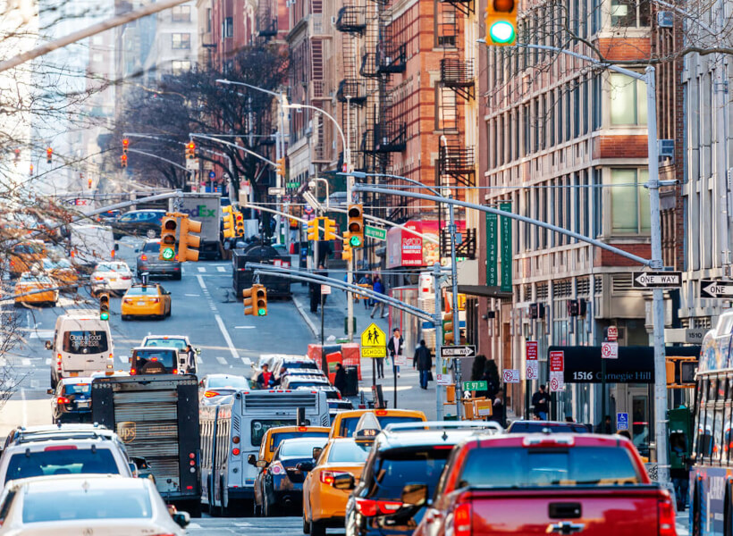Vibrant East Harlem traffic, part of Uptown Manhattan's diverse real estate landscape.