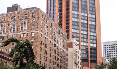 Murray Hill streetscape, blend of historic brownstones and modern skyscrapers.