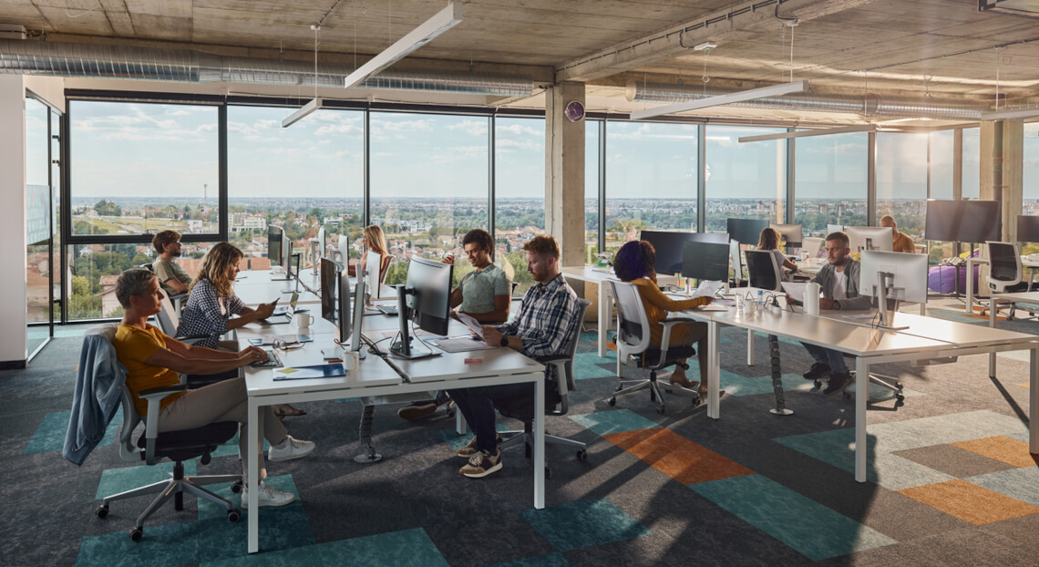 Programmers in a modern NYC office, symbolizing the transition from coworking to private space.