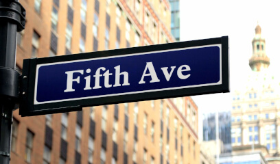 Fifth Avenue street sign, epitome of prestige in NYC's Madison/Fifth office submarket.