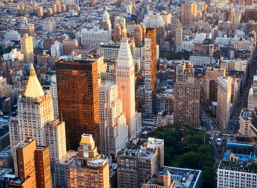 New York City rooftop view with Downtown Manhattan skyscrapers and urban cityscape.