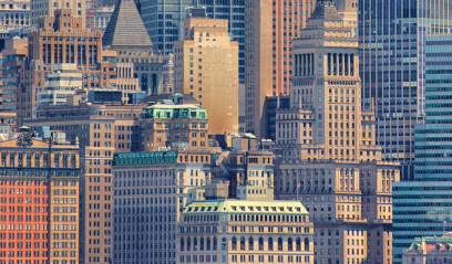 Wall Street skyline close-up, diverse skyscrapers in NYC's Financial District.