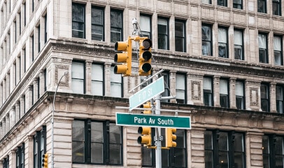 Park Ave South & 17th East St signs, prime office space guide in NYC's commercial heart.