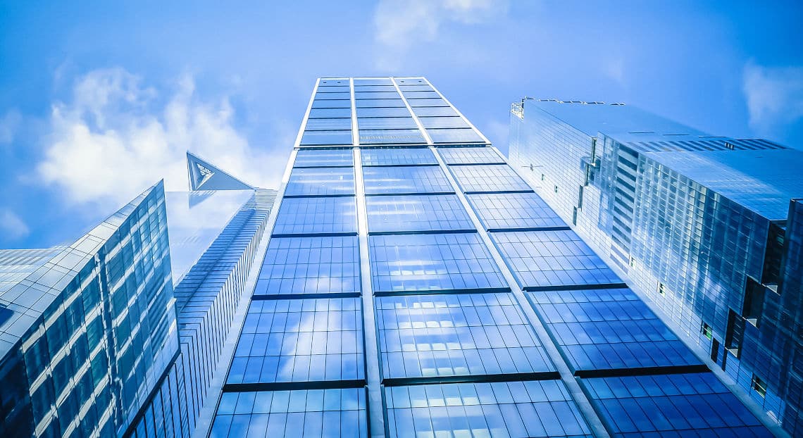 50 Hudson Yards, pinnacle of luxury in NYC skyline, against blue sky backdrop.