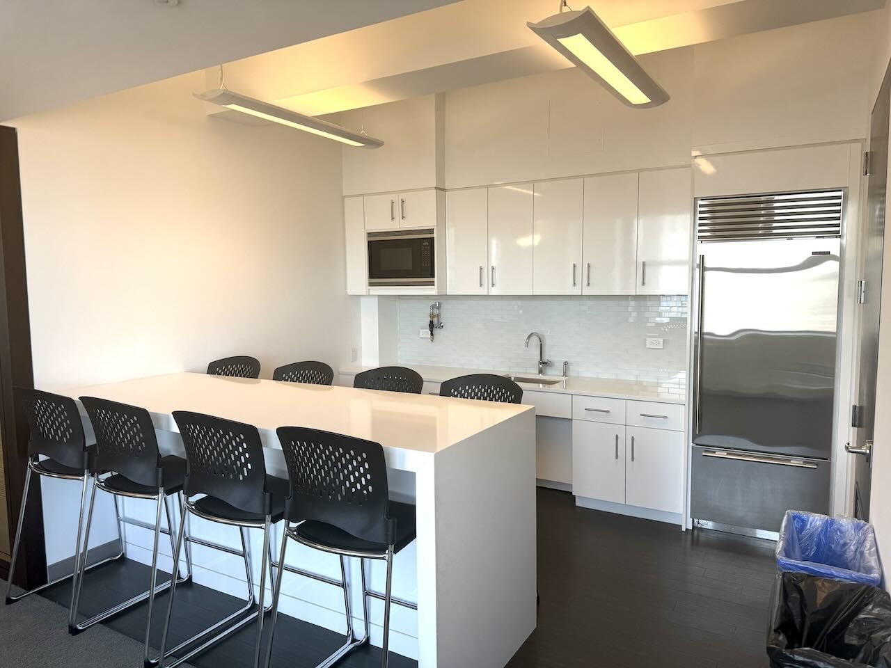 Address, Office Space, Suite Number: 12345 Example St, Office Space, Suite 678

ALT Tag: Modern kitchen with white island countertop, black chairs, white cabinets and stainless steel appliances.