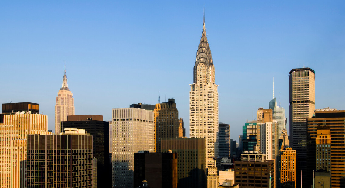 Midtown Manhattan skyline with Chrysler Building under blue sky