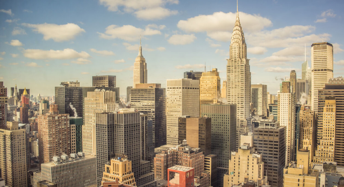 NYC skyline with tall buildings, Empire State and Chrysler in view.
