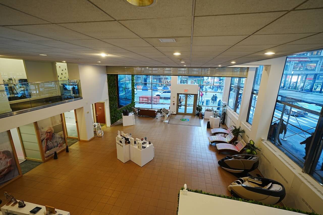 Modern ground-floor showroom with large windows, displays, massage chairs, and city views at 515 Seventh Ave.