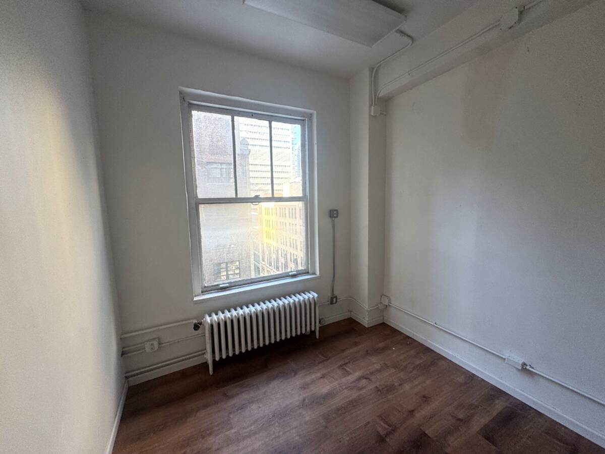 Windowed office room with radiator heating