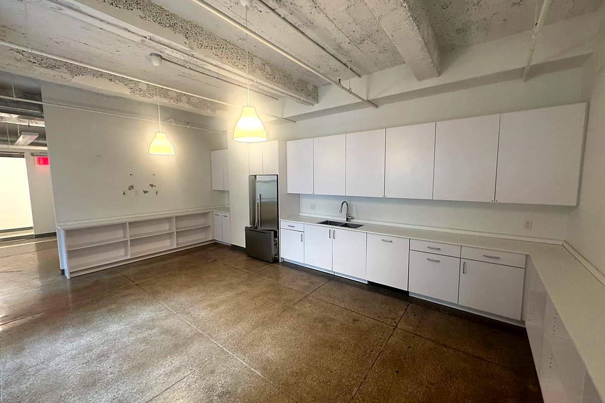 Breakroom with kitchen and exposed ceilings