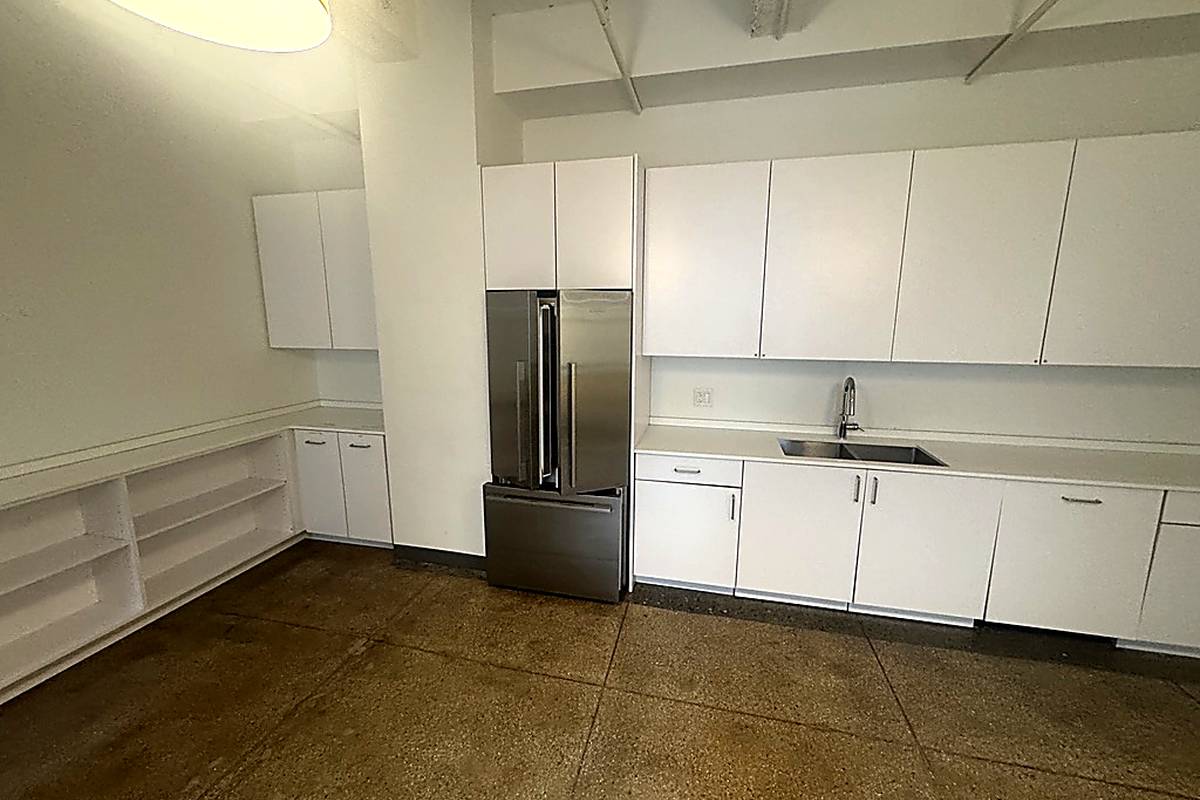 Modern white kitchen with stainless appliances