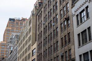 A row of typical old brick skyscrapers and buildings along a street in Chelsea of New York City